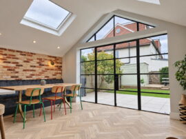 Twickenham kitchen extension with black-framed glazing, rooflights and herringbone wood flooring